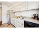 A bright kitchen showcasing white cabinets, modern appliances, and ample counter space at 12360 W Nevada Pl # 206, Lakewood, CO 80228