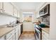 Bright kitchen with white cabinetry, stainless steel appliances, and a view of the outside at 12360 W Nevada Pl # 206, Lakewood, CO 80228