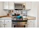 Modern kitchen design boasting stainless steel appliances, a tile backsplash, and lots of natural light at 12360 W Nevada Pl # 206, Lakewood, CO 80228