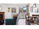 View of the living room with a balcony, hardwood floors, and a cozy dining area, creating a warm atmosphere at 12360 W Nevada Pl # 206, Lakewood, CO 80228