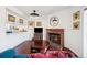 Bright living room with a cozy brick fireplace, modern lighting, and views into the kitchen at 12360 W Nevada Pl # 206, Lakewood, CO 80228