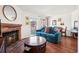 Comfortable living room with a brick fireplace and access to the balcony that provides natural light and views at 12360 W Nevada Pl # 206, Lakewood, CO 80228