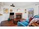Cozy living room featuring a brick fireplace, dark wood floors, and a sliding door to a balcony at 12360 W Nevada Pl # 206, Lakewood, CO 80228