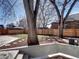 Landscaped backyard with mature trees, privacy fence, and a lush lawn at 1378 Forest St, Denver, CO 80220