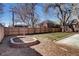 Fully fenced yard has a circular, brick-lined planting area and a level grassy section at 1378 Forest St, Denver, CO 80220