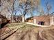 Backyard view with lush lawn, privacy fence, and brick building at 1378 Forest St, Denver, CO 80220