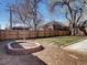 Backyard features a brick fire pit, lawn and new privacy fence at 1378 Forest St, Denver, CO 80220
