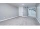 A finished basement features neutral paint, carpet, and a doorway to the stairs at 1378 Forest St, Denver, CO 80220