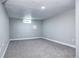 A spacious basement features neutral paint, carpet, and a small window at 1378 Forest St, Denver, CO 80220