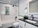 Stylish bathroom featuring black and white tiles, modern fixtures, and a bathtub with shower at 1378 Forest St, Denver, CO 80220