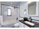 Updated bathroom featuring white subway tile, black accents, and modern fixtures throughout at 1378 Forest St, Denver, CO 80220