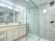 Modern bathroom featuring double vanity and glass enclosed shower with tiled walls at 1378 Forest St, Denver, CO 80220