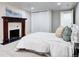 Bedroom with a fireplace and white closet, large bed, and natural light at 1378 Forest St, Denver, CO 80220