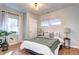 Bright bedroom with hardwood floors, a cozy bed, and natural light from multiple windows at 1378 Forest St, Denver, CO 80220
