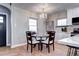 Charming dining area featuring a chandelier, wood floors, and seating for four near kitchen at 1378 Forest St, Denver, CO 80220