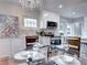 Dining area with a glass table, chandelier, and an open view into the updated kitchen at 1378 Forest St, Denver, CO 80220