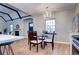 Cozy dining area featuring a modern chandelier and views into the living room and kitchen at 1378 Forest St, Denver, CO 80220