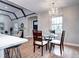 Open dining area featuring a chandelier, views into the living room, and a modern kitchen at 1378 Forest St, Denver, CO 80220