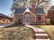 Charming red brick house with a gabled roof, a front yard, and a brick chimney in a lovely community at 1378 Forest St, Denver, CO 80220