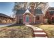 Charming brick home has a walkway leading to the front door, with a gabled roof and mature landscaping at 1378 Forest St, Denver, CO 80220