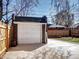 Detached one-car garage, made of red brick and a white door, sits at the back of a private fenced-in yard at 1378 Forest St, Denver, CO 80220