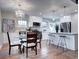 Updated kitchen and dining area with stainless steel appliances, quartz countertops, and bar seating at 1378 Forest St, Denver, CO 80220
