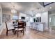 Open kitchen and dining area with white cabinets, stainless steel appliances, and hardwood floors at 1378 Forest St, Denver, CO 80220