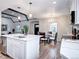 Spacious kitchen with island, dining area, modern lighting, and stainless steel appliances at 1378 Forest St, Denver, CO 80220