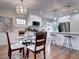Open kitchen and dining area with bar seating, stainless appliances, and ample counter space at 1378 Forest St, Denver, CO 80220