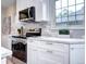 Well-lit kitchen showcasing white cabinetry, stainless steel appliances, and subway tile backsplash at 1378 Forest St, Denver, CO 80220