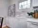 Bright kitchen detail with updated white cabinets, backsplash, and under-cabinet lighting at 1378 Forest St, Denver, CO 80220