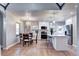 Modern kitchen with stainless steel appliances, white cabinets and dining area at 1378 Forest St, Denver, CO 80220