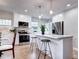 Modern kitchen with an island, stainless steel appliances, and a view into the dining area at 1378 Forest St, Denver, CO 80220