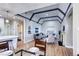 Living room with open layout to kitchen, a fireplace, and eye catching ceiling beams at 1378 Forest St, Denver, CO 80220