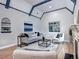 Bright living area with fireplace, vaulted ceiling, hardwood floor, and archway at 1378 Forest St, Denver, CO 80220