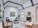 Living room with vaulted ceiling, fireplace, hardwood floors and neutral decor at 1378 Forest St, Denver, CO 80220