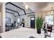 Bright living room with a fireplace, beamed ceiling and hardwood floors, seamlessly connecting to dining area at 1378 Forest St, Denver, CO 80220