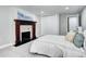 Main bedroom showcasing a decorative fireplace, plush carpet, and a closet with sliding doors at 1378 Forest St, Denver, CO 80220