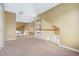 Open hallway featuring a staircase and a view into another room at 11248 W Ford Dr, Lakewood, CO 80226