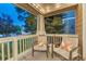 Back porch with patio furniture, string lights, and hanging ferns, creating a cozy outdoor space at 13053 Umatilla Ct, Denver, CO 80234