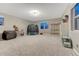 Spacious basement with gray carpet, natural light, a variety of toys, and plenty of room for activities at 13053 Umatilla Ct, Denver, CO 80234
