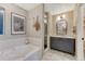 Bathroom showcasing a gray vanity with a marble countertop, subway tile walls, and a glass-enclosed shower at 13053 Umatilla Ct, Denver, CO 80234