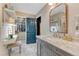 Bathroom with vanity, open closet, makeup space and blue door at 13053 Umatilla Ct, Denver, CO 80234