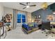 The bedroom boasts a blue accent wall, fan, and decor at 13053 Umatilla Ct, Denver, CO 80234