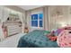 Cozy bedroom featuring a teal bed, a window, a colorful rainbow decoration, and closet with shelving at 13053 Umatilla Ct, Denver, CO 80234