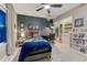 Nicely decorated bedroom with bed, desk, closet with shelving and decorations at 13053 Umatilla Ct, Denver, CO 80234