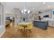 Bright dining area with yellow chairs and hardwood floors connected to a kitchen at 13053 Umatilla Ct, Denver, CO 80234