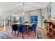 Dining room featuring a wooden table, blue chairs, a colorful rug and chandelier at 13053 Umatilla Ct, Denver, CO 80234