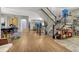 Spacious entryway with hardwood floors, a staircase, and a view of the living and dining areas at 13053 Umatilla Ct, Denver, CO 80234