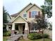 Charming two-story home with a covered front porch and mature landscaping at 13053 Umatilla Ct, Denver, CO 80234